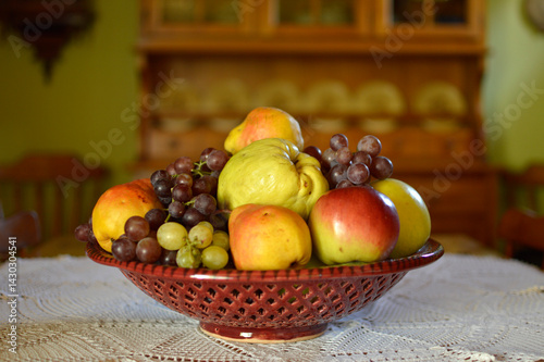 Obraz na płótnie ceramic bowl with various ripe fruits at the table w salonie