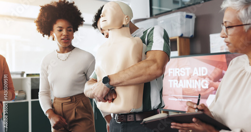 Fotografía First aid, training and people with choking dummy for CPR, abdominal thrusts and life saving procedure in office