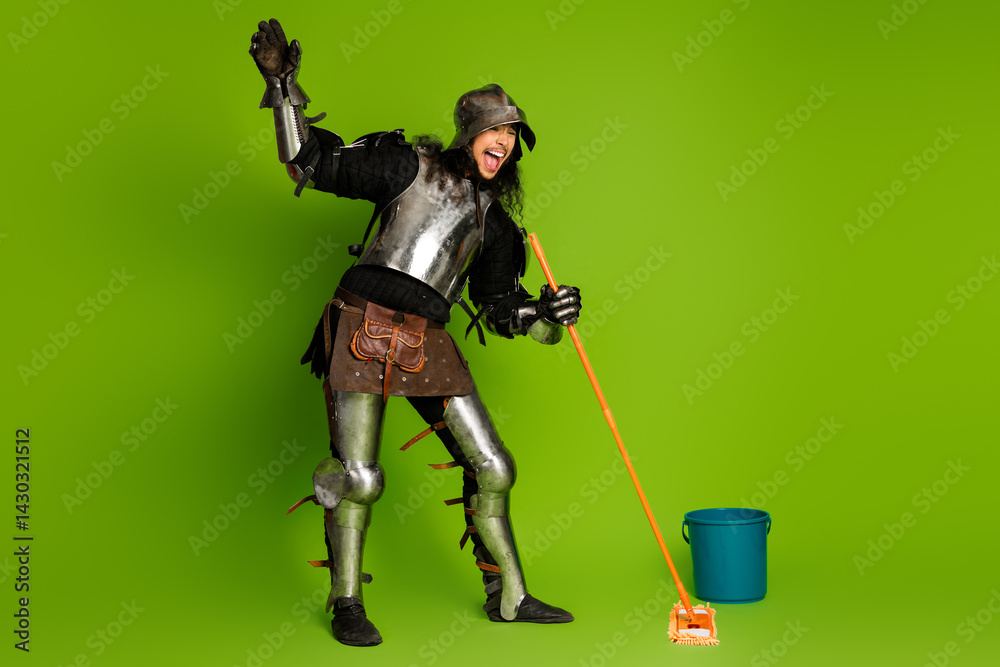 Obraz premium Knight in shining armor humorously mopping the floor against a vibrant green background