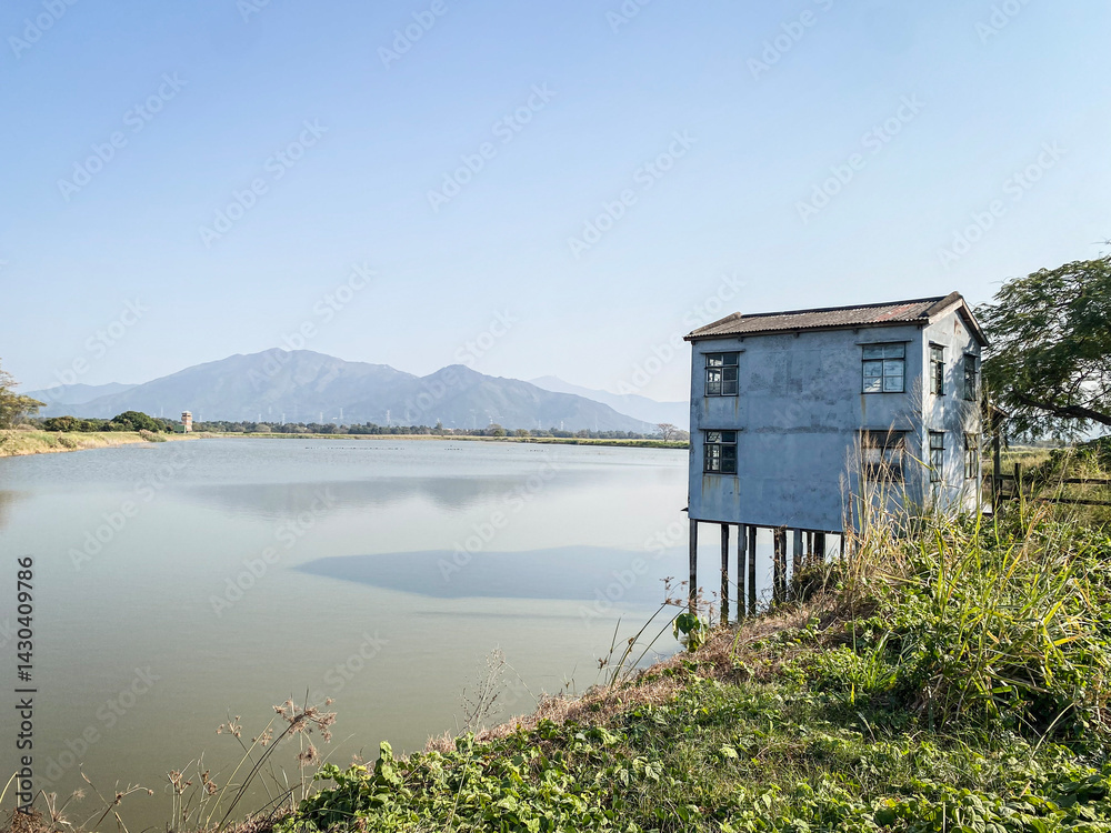 Rural Landscape with Dilapidated House by a Pond in Hong Kong