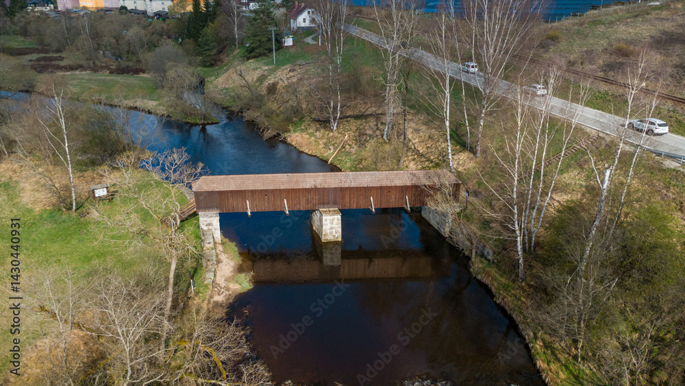 The picturesque covered wooden bridge Rechle near Lenora in the Šumava mountains – a unique national cultural monument - historic bridge with a wooden deck and stone pillars