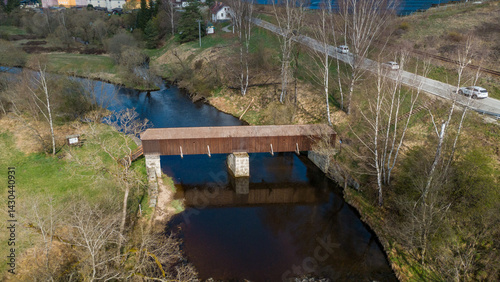 Obraz na płótnie The picturesque covered wooden bridge Rechle near Lenora in the Šumava mountains – a unique national cultural monument - historic bridge with a wooden deck and stone pillars w salonie