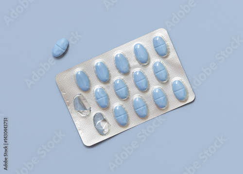 Obraz na płótnie Blue pills in blister with some missing pills already used on blue top view. Medicine and healthcare w salonie