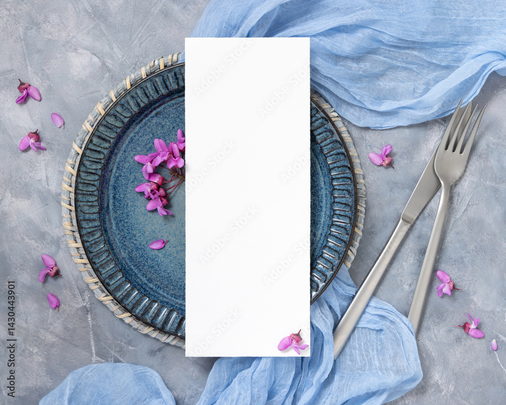 Wedding table place with a card near fabric and wild purple flowers top view on gray, spring mockup