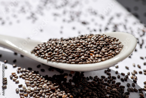 organic chia seeds on a white background, supporting immunity and enriching the diet with useful microelements. healthy lifestyle concept, cooking, nutrition.