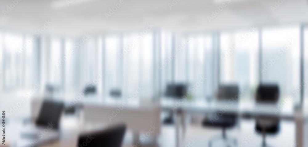Blurred interior view of a modern office space with desks and chairs. Elegant business background for banner display background, magazine poster and web display. Blurred interior view of a modern office space with desks and chairs. Elegant business background for banner display background, magazine poster and web display.