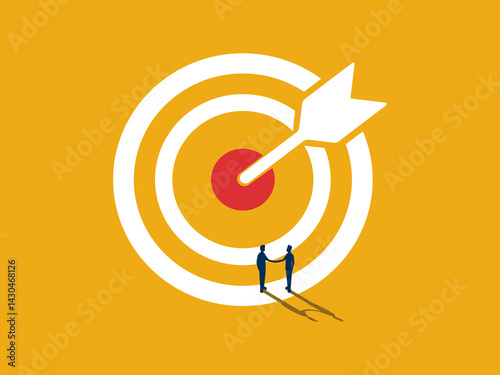 Achieve a common goal, Two businessmen shaking hands on a large target.