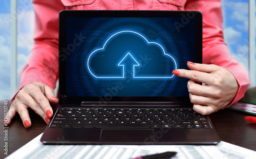 Businesswoman in office and laptop with cloud computing interface.