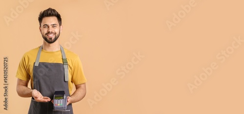 Young bearded man in apron ...
