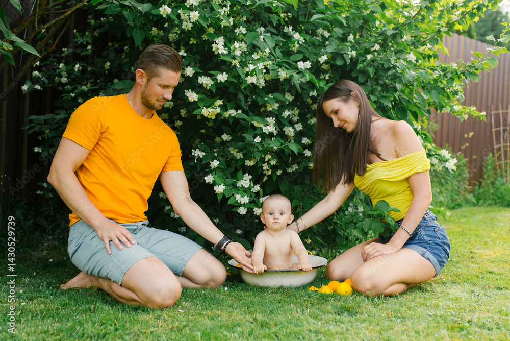 Family with Baby in Small Tub Outdoors