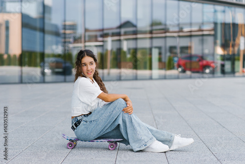 Obraz na płótnie Girl Sitting On Colorful Skateboard w salonie