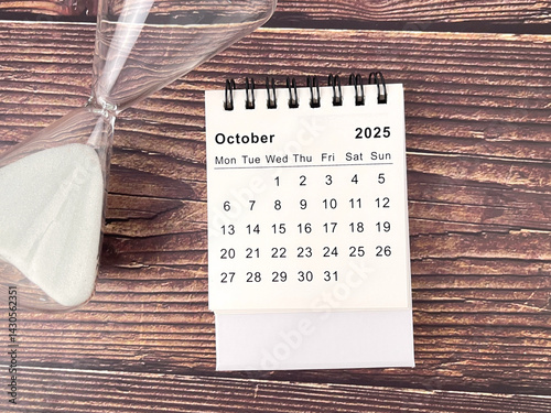 2025 October desk calendar flat lay on wooden table