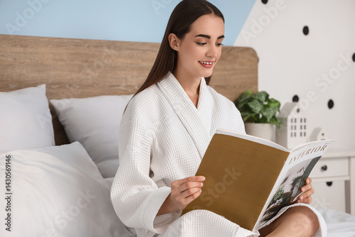 Young woman in bathrobe rea...