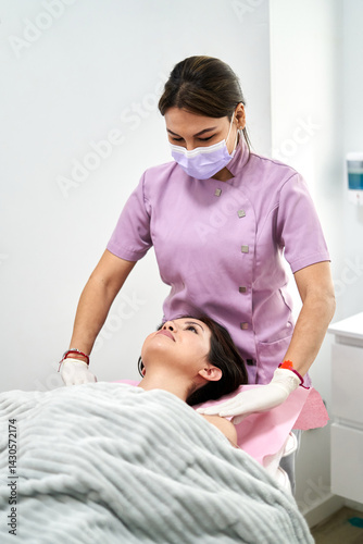 Beauty Therapist Performing Facial Treatment in Clean Clinic