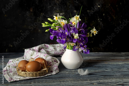 A bouquet with narcissus and irises, nest and eggs in vintage style