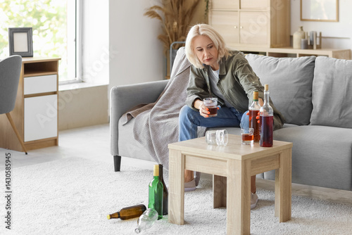 Mature woman drinking alcoh...