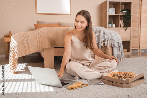 Young woman in pajamas with...