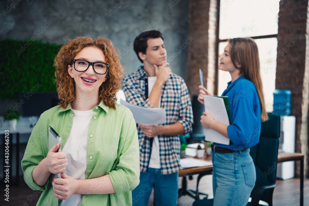 Obraz premium Group of young professionals collaborating in a modern office environment fostering teamwork and creativity