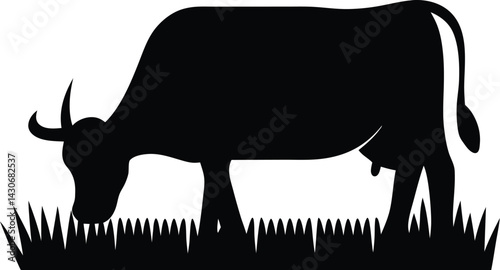Black silhouette of a cow grazing on grass, side view