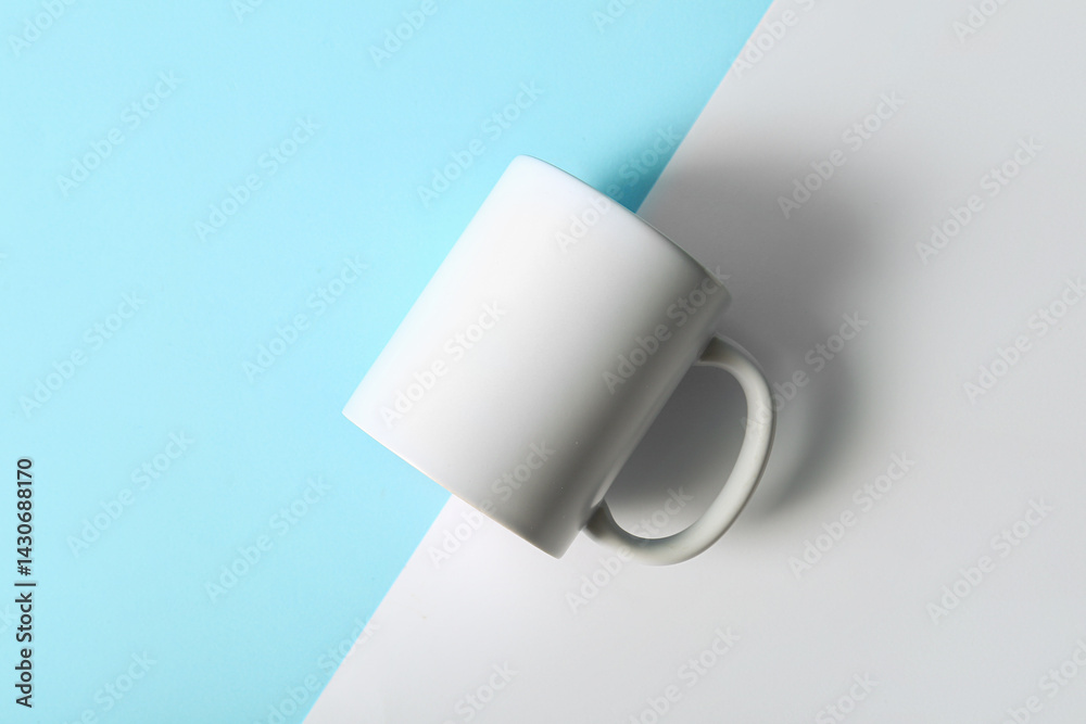 Ceramic white mug on colorful background. Top view