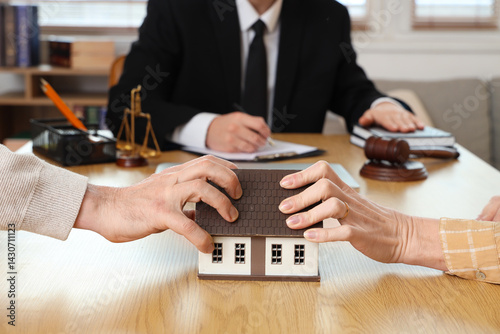 Mature couple dividing house at divorce lawyer's office, closeup