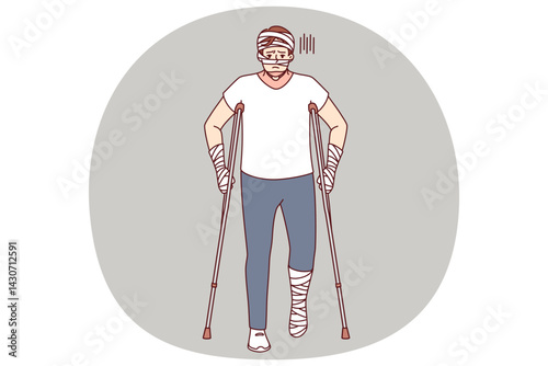 Ill man with bandages on hands and head uses walking aids after being involved in car accident. Guy injured in car accident needs long-term treatment and rehabilitation to restore health