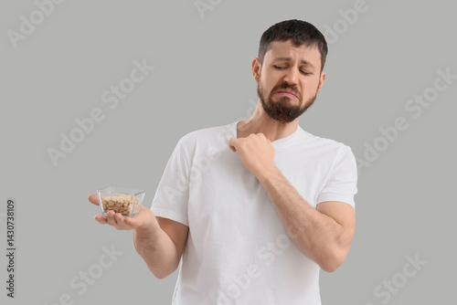 Young man with nuts on ligh...