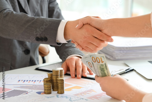 Business handshake with mon...