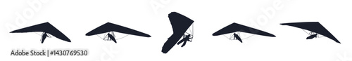 Black silhouettes hang glider or parachute skydiving