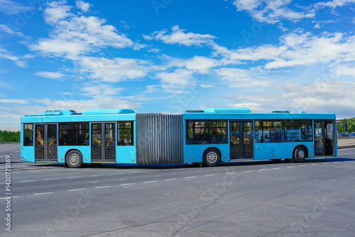 Passenger lengthened articulated bus city bus of blue color turn rides at the highway