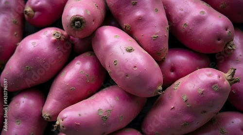 Close-up of vibrant red sweet potatoes, yams, ullucus, and cherie potatoes. Ideal for food blogs, recipe sites, and healthy eating promotions.