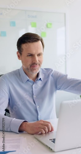 Vertical video of mature businessman at office smiling portrait
