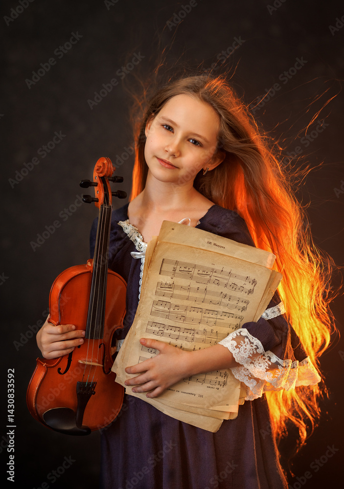 Portrait of a beautiful girl with developing long hair and a violin on a dark background in the studio. Music and art