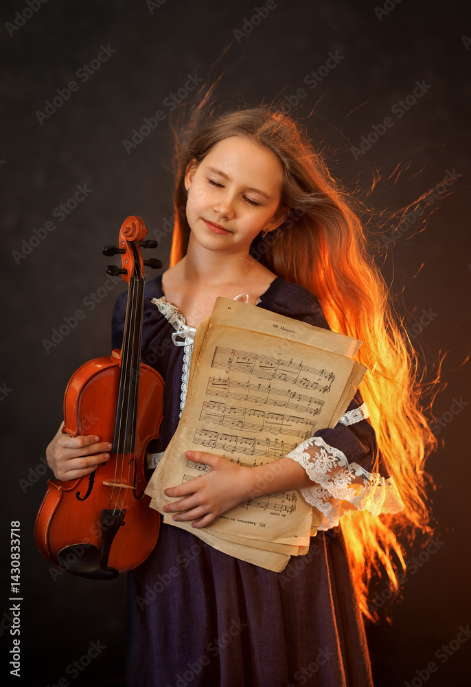 Portrait of a beautiful girl with developing long hair and a violin on a dark background in the studio. Music and art