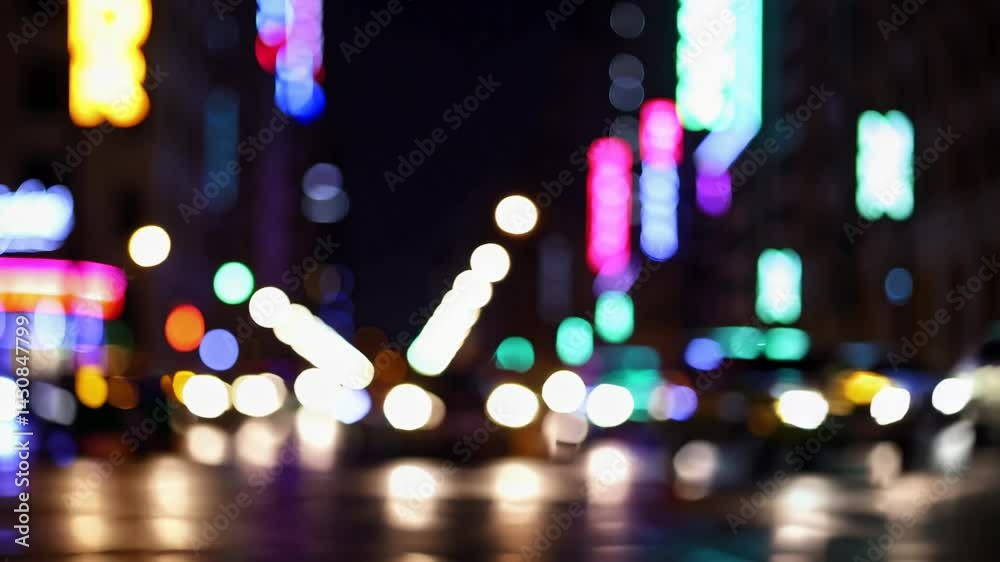 Colorful city lights bokeh effect at night, blurred abstract background of glowing neon urban illumination, representing nightlife, motion, and dreamy cityscape atmosphere