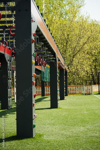 Obraz na płótnie Sports ground outdoors for kids and adult. Successful training concept. Open air gym, street workout concept. Hanging monkey bars on kids playground. w salonie