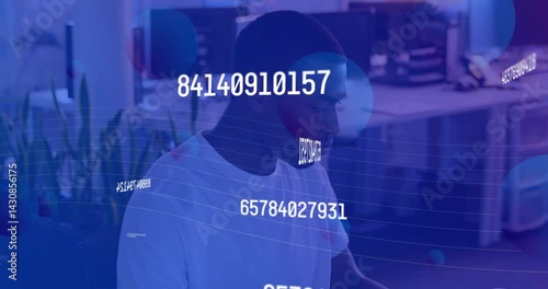 Developer coding at desk in tech office, projecting floating numeric codes and wave grid lines