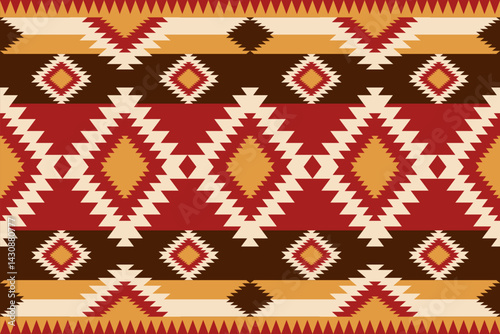 An intricately designed Southwestern textile features geometric patterns in warm colors providing a rustic and tribal inspired background aesthetic.