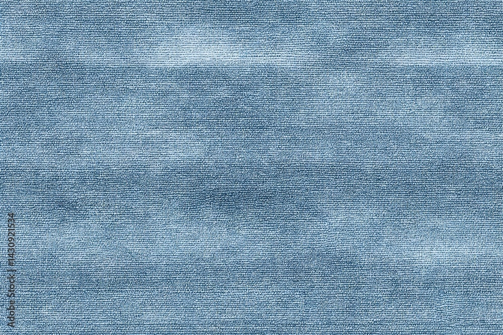Softly shadowed, light blue denim texture creates a clean and seamless backdrop, ideal for versatile design applications.