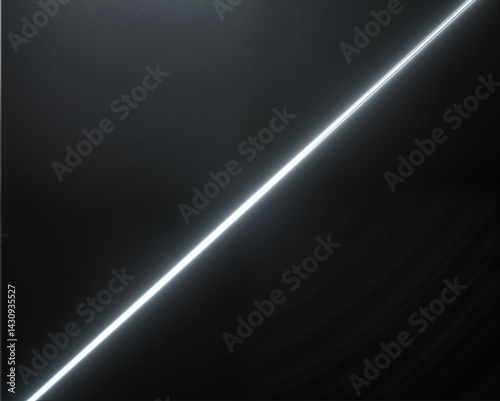 A minimalist image featuring a diagonal beam of light cutting through a dark background, creating a striking contrast.