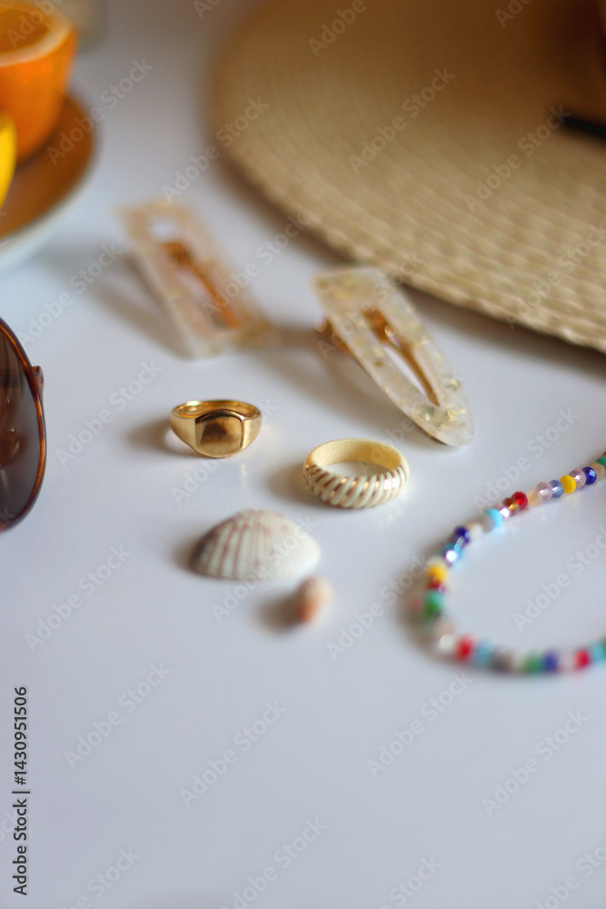 Glass of cocktail, straw hat, sunglasses, books, fresh fruit, chocolate and accessories. Summer essentials on the table. Selective focus.