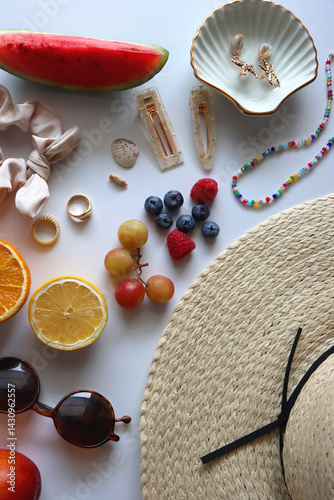 Straw hat, sunglasses, seasonal fruit, seashells and colorful accessories on white backgrounds. Cute summer essentials. Flat lay.