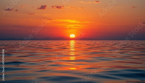Golden Sunset Reflecting on Calm Ocean Water with Orange and Red Hues