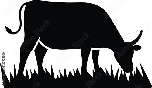 A black silhouette of a cow grazing in a field of grass on a white background plain