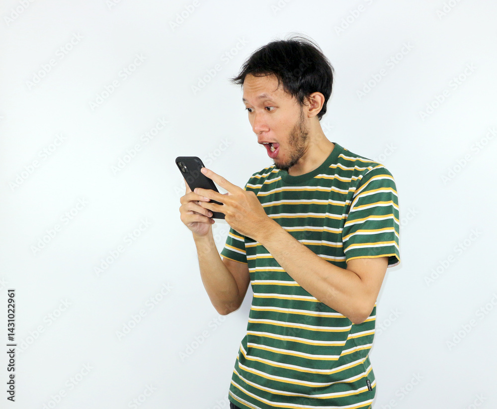 Surprised Man Looking at Phone Screen with Shocked Facial Expression Surprised Man Looking at Phone Screen with Shocked Facial Expression