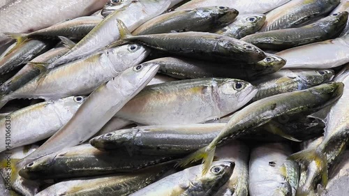 Mackerels are placed on trays for sale at a seafood market.