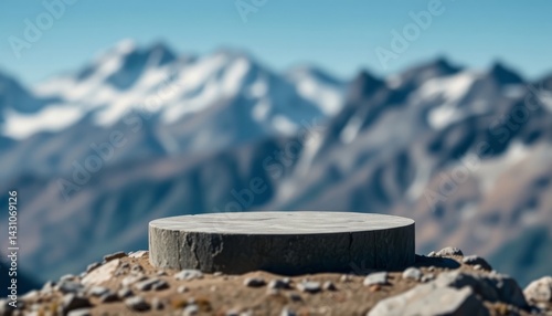 Empty stone display podium on a mountain peak with a blurred landscape. Nature, outdoor concept with copy space for product placement.