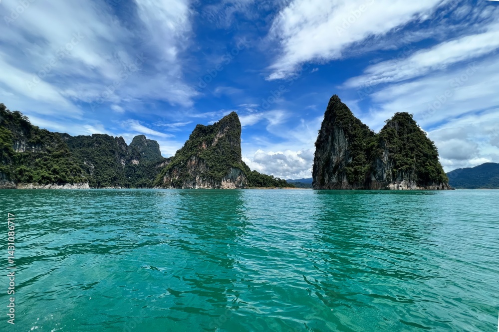 A stunning view of rocky islands surrounded by turquoise waters under a vibrant sky, showcasing the beauty of nature. A stunning view of rocky islands surrounded by turquoise waters under a vibrant sky, showcasing the beauty of nature.