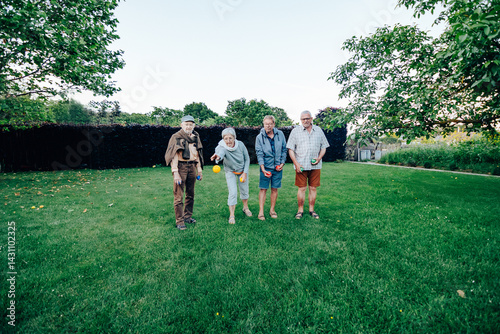 Senior friends playing bocce ball in the park