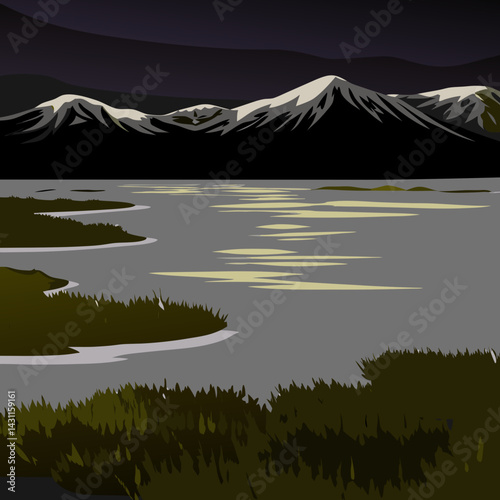 A tundra landscape with frozen ground, icy water, low shrubs, and snow-capped mountains in the distance.